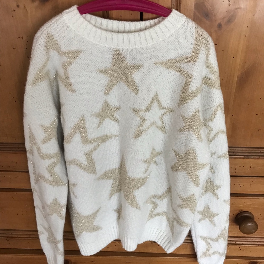 Cream colored crew neck sweater with gold stars